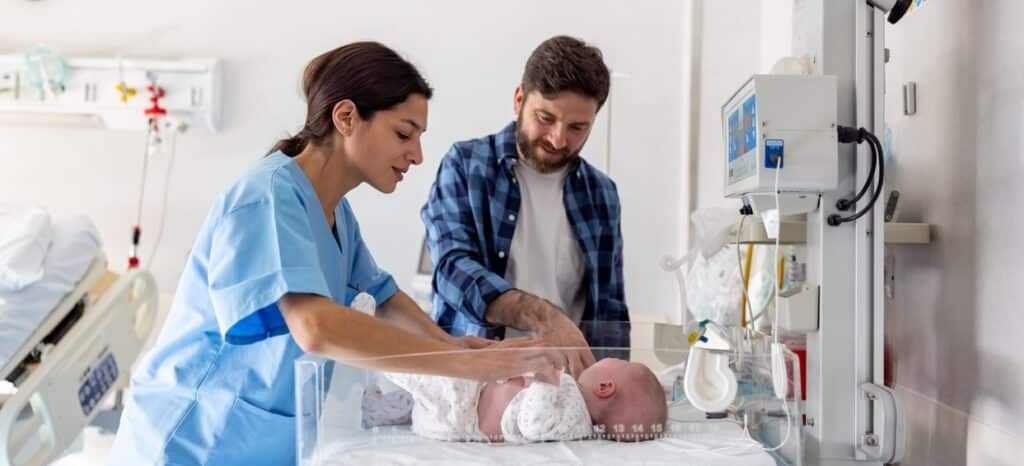 birth injury lawyers at WKW, image of new baby in hospital with nurse and father
